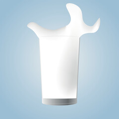 A glass of milk in the blue background. milk splashing in a glass