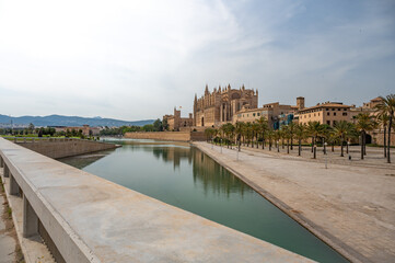 La Seu Cathedral Santa Maria of Palma, Majorca view from the distance with lake and fence in front, wide angle shot, Mallorca