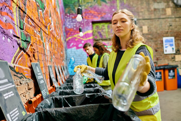 A woman standing beside a vibrant graffiti-covered wall, expressing urban creativity and culture.