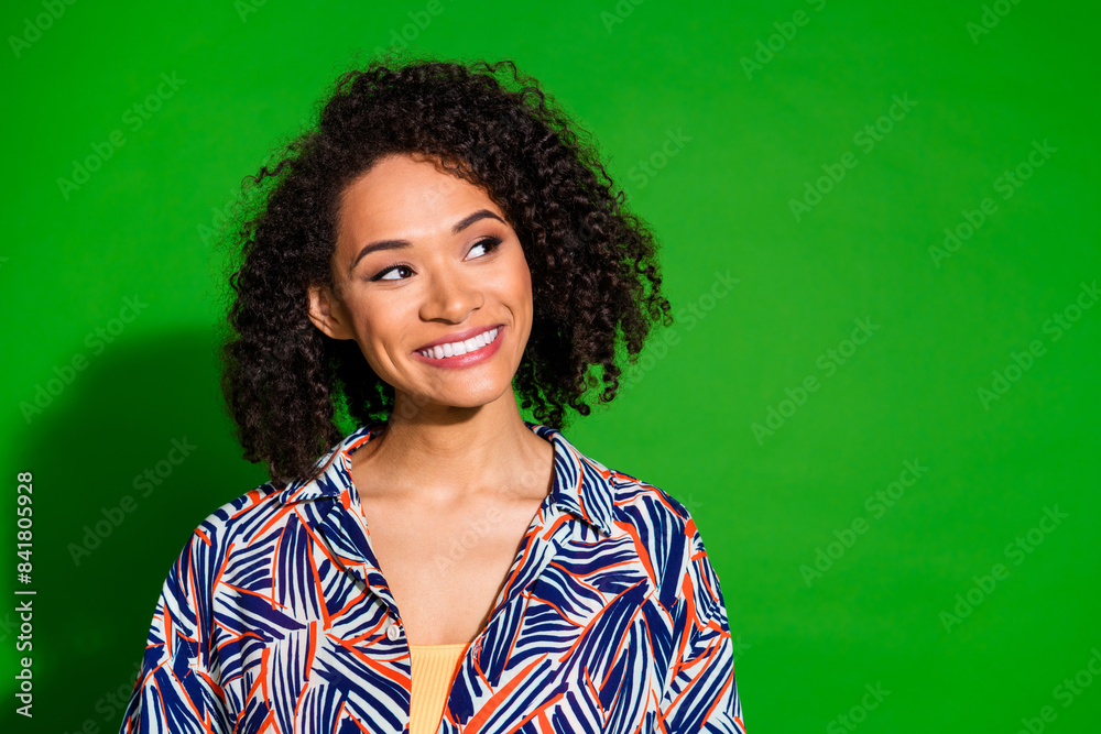 Wall mural photo of shiny attractive lady dressed print shirt smiling looking empty space isolated green color 