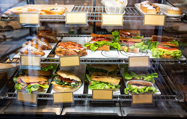 Display case of sandwiches,hamburger and pastries in cafe