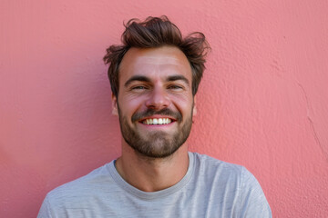 A close up portrait of a young man with a subtle smile
