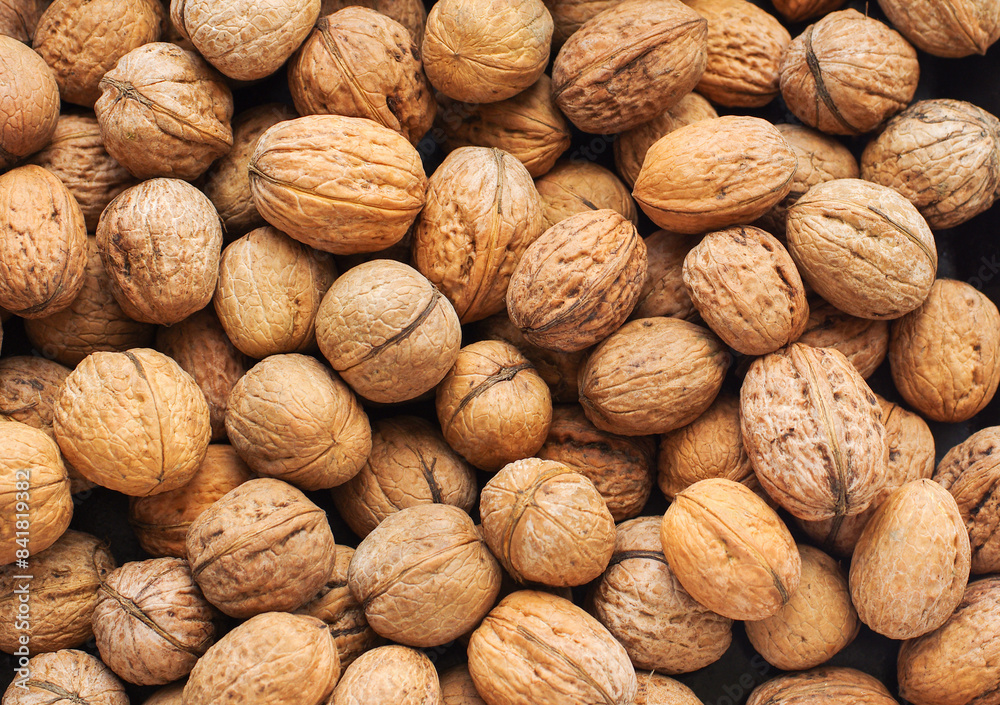 Wall mural top view of whole walnuts as background texture - Wall murals