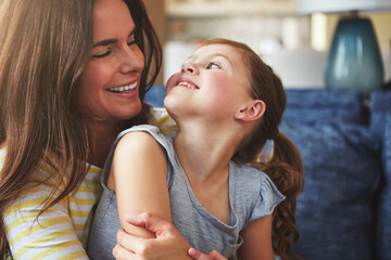 Woman, hug and child with love on sofa house for trust, bonding and support of relationship moment. Smile, mother and girl as family for care, security or relax with embrace on couch for childhood