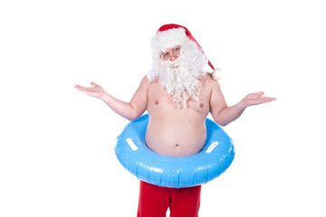 Vacations and holidays. Funny Santa Claus with an inflatable ring dreams of the sea. White...