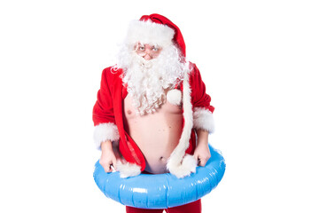 Vacations and holidays. Funny Santa Claus with an inflatable ring dreams of the sea. White background.