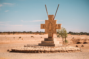 Cross-shaped monument with Aymara-style sculptures situated at the entrance of the Moon Valey...