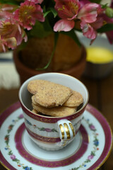 cup of coffee, cup of coffee and flowers, cup of tea and cookies