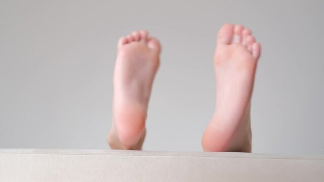 legs of a 9 year old boy having fun lying on the sofa