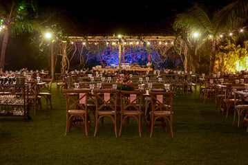table set for a dinner, restaurant in the city, cafe in the city, restaurant in the night, restaurant tables and chairs, restaurant tables in the garden, hanging lights, christmas tree at night
