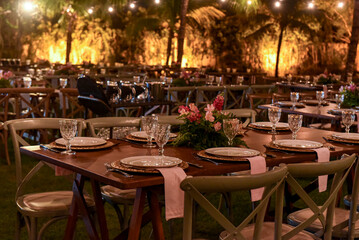 table set for a dinner, restaurant in the city, cafe in the city, restaurant in the night, restaurant tables and chairs, restaurant tables in the garden, hanging lights, christmas tree at night
