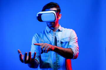 Caucasian smart man with VR glasses while holding hologram display in VR. Happy person holding and...