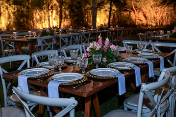 table set for a dinner, restaurant in the city, cafe in the city, restaurant in the night, restaurant tables and chairs, restaurant tables in the garden, hanging lights, christmas tree at night
