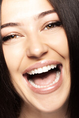 Close up view of a womans face with open mouth showing her teeth. Girl talking or screaming or...