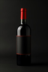 Fototapeta premium Wine bottle with red top on dark background