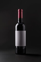 Wine bottle with red top on dark background