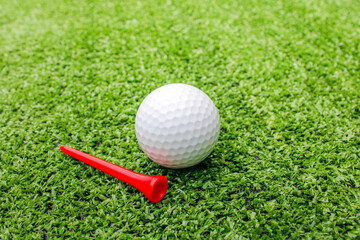 Golf ball placed on artificial grass.
