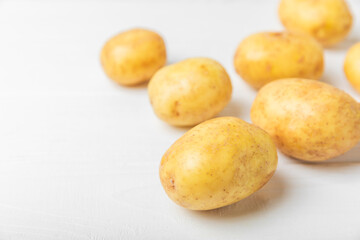 Young potatoes. Fresh potatoes  on a wooden background.Harvesting collection. organic, freshly dug potatoes. Agricultural background. Vegan. Vegetables.Place for text.Copy space