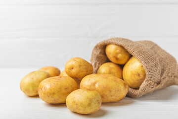 Young potatoes. Fresh potatoes  on a wooden background.Harvesting collection. organic, freshly dug potatoes. Agricultural background. Vegan. Vegetables.Place for text.Copy space