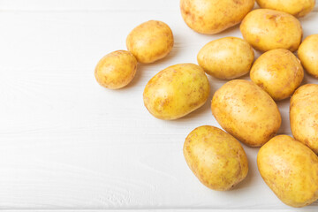 Young potatoes. Fresh potatoes  on a wooden background.Harvesting collection. organic, freshly dug potatoes. Agricultural background. Vegan. Vegetables.Place for text.Copy space