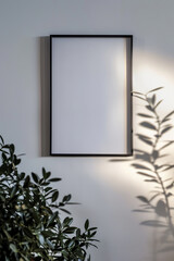 Minimalist metal picture frame on a white backdrop, viewed from above, with bright lighting and a sleek design.