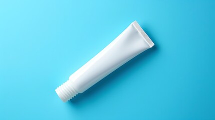 Blank tube of toothpaste on color background