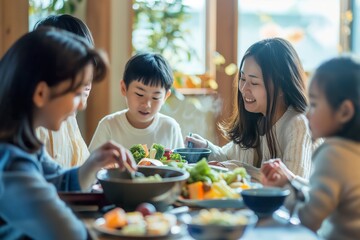 A multicultural group sits around a table, enjoying a meal together with smiles and conversation.