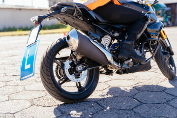 Obraz premium Female student moto school learning to ride a motorcycle.