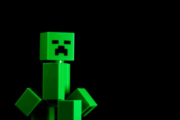 Fototapeta premium LEGO Minecraft green Creeper Mob on the black background