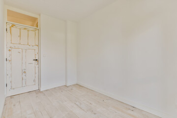 Empty room with aged wooden door and floor