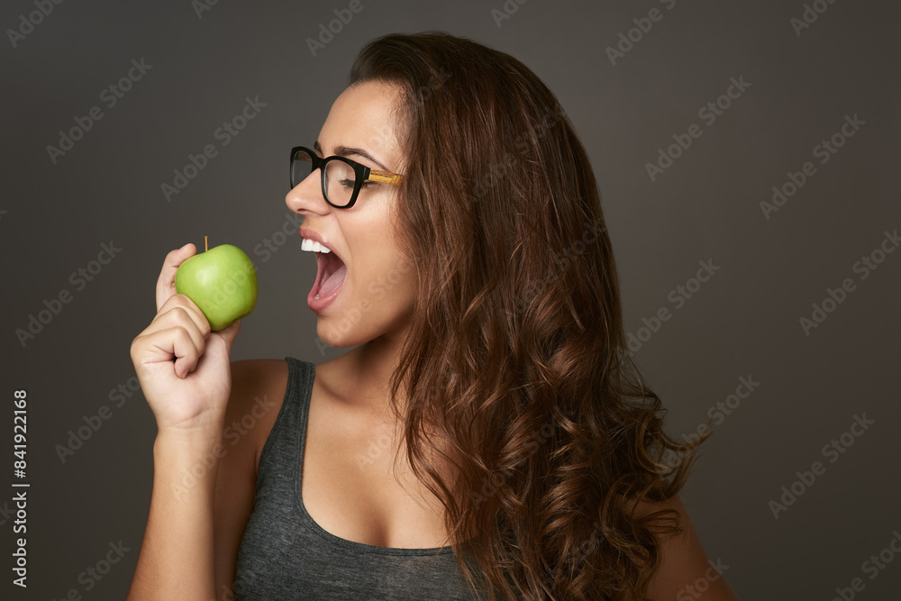 Sticker Studio background, bite and apple with woman for eating, vitamin c and mineral for nutrition. Female nutritionist, organic fruit and healthy diet for detox, weight loss or product benefits with pride