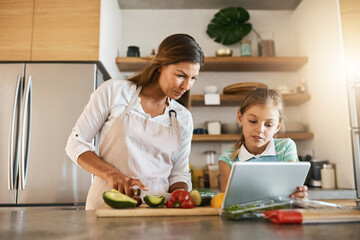 Woman, child and cooking with tablet, online for recipe or ingredients on kitchen counter for dinner. Family, healthy and food or meal prep for nutrition, together or bonding for clean eating in home