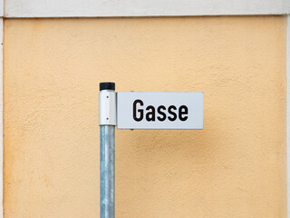 Gasse (alleyway) road name sign in Germany. Street address in a German town in front of a house...