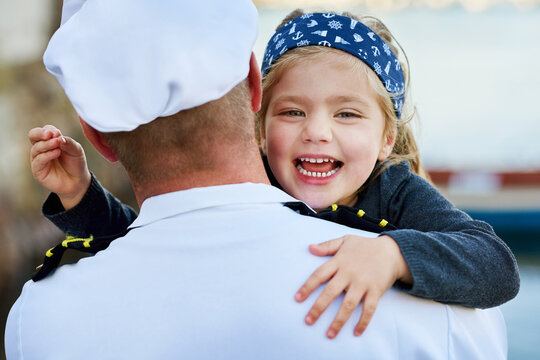 Portrait, happy kid and reunion with father from navy, service and excited on dock. Man, young daughter and hug outdoors for welcome, love and happiness for return from work, deployment and uniform - Powered by Adobe