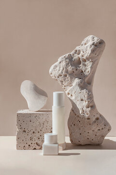 White pieces of stone rocks with blank tube and jar for mock-up product presentation. Mock-up for exhibitions or presentation of cosmetic products or packaging with natural stones