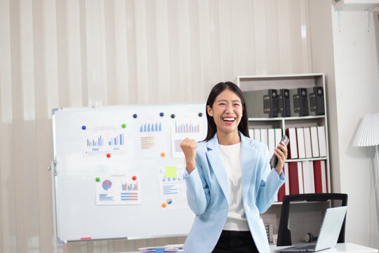 Beautiful Asian business woman uses digital tablet and laptop to do remote work at the office, online seminar or video call. - Powered by Adobe