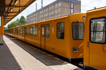 Old yellow underground train of the city of Berlin. Underground train at the station.