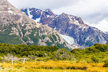 Fototapeta premium Patagonia mountains in El Chalten, Argentina. Monte Fitzroy and Cerro Torre summits granite walls above lake laguna Torre with icebergs floating ice and dark clouds nasty patagonian weather 