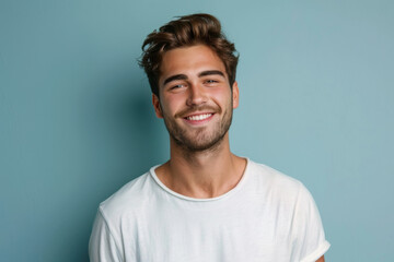 A close up portrait of a young man with a subtle smile