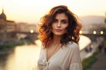 beautiful young italian woman smiling for tourism advertisment campaign in a florence with sunset