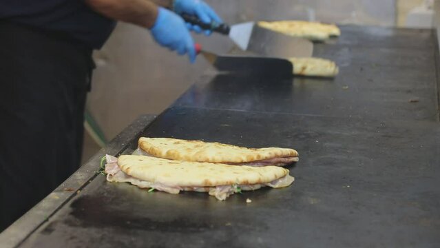 typical Italian flatbread called Piadina Romagnola or Spianata Bolognese being cooked 