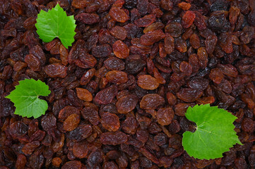 pile of organic dried fruits raisins and grape leaves