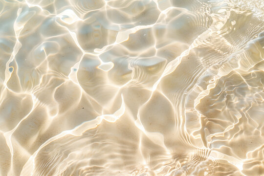 Transparent clear sea summer holiday abstract water waves with sunlight shadows on beige sandy beach background close up detail, travel and adventure concept.