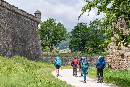 Way of St. James. Group of pilgrims on the Walls of Pamplona