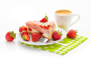 A piece of cake with strawberry souffle, fresh strawberries and a cup of coffee on a green napkin. Isolate on a white background