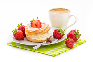 A cream pie, fresh strawberries and a cup of coffee on a green napkin. Isolate on a white background