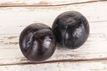 Two ripe sweet black plums