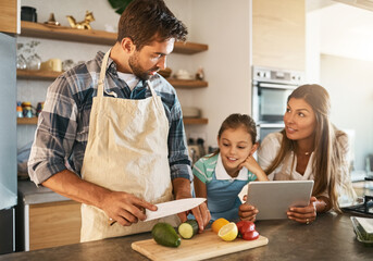 Family, nutrition and diet with people, tablet and ingredients for salad recipe on kitchen counter...