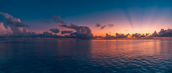 Beautiful sea ocean horizon. Skyscape seascape. Orange gold purple  sunset sky reflection calmness water surface, tranquil relaxing sunlight, summer mood. Inspirational nature view, wide horizon sky. 