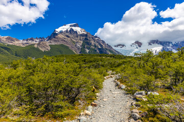 Patagonia mountains in El Chalten, Argentina. Monte Fitzroy and Cerro Torre summits granite walls above lake laguna Torre with icebergs floating ice and dark clouds nasty patagonian weather 